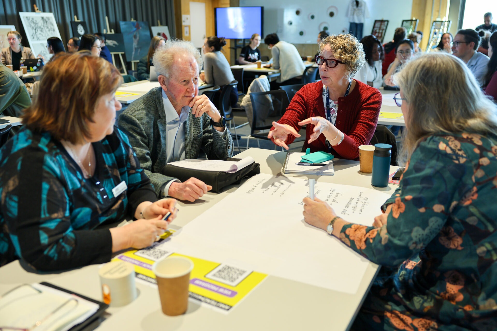 Participants exchange ideas around a table at the Showcase.