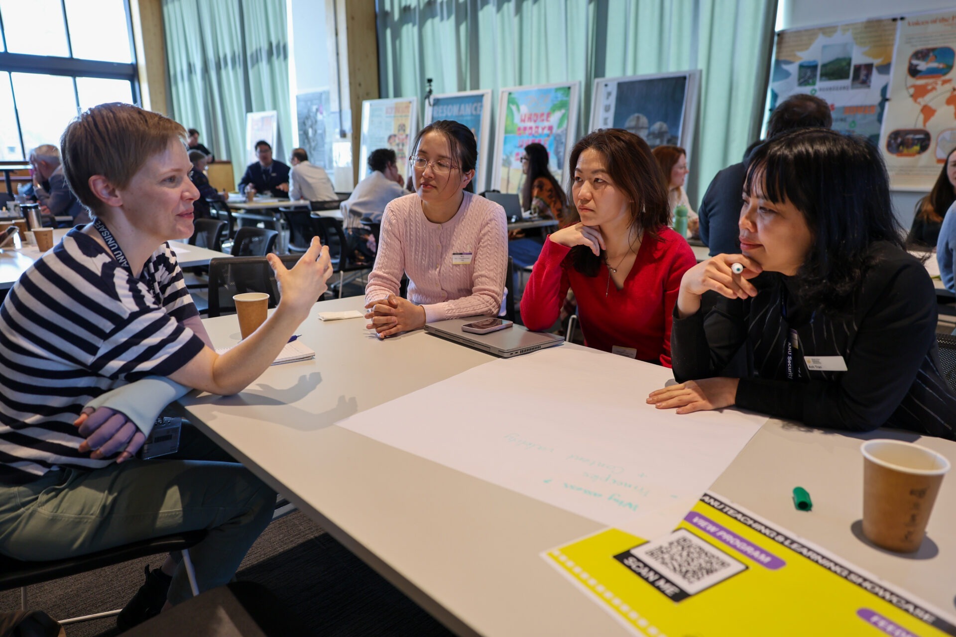 Four participants share ideas around a table.