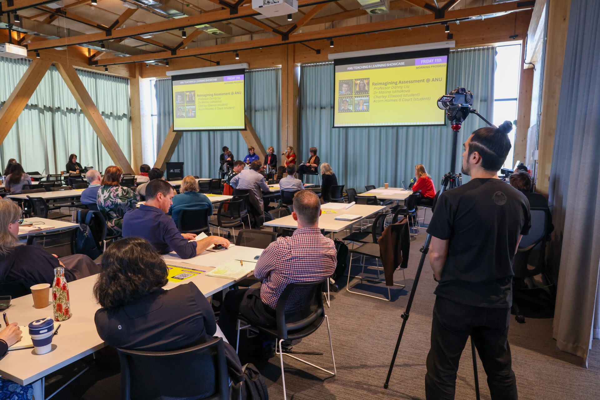 A wide view of participants and the presentation area at the Teaching and Learning Showcase.