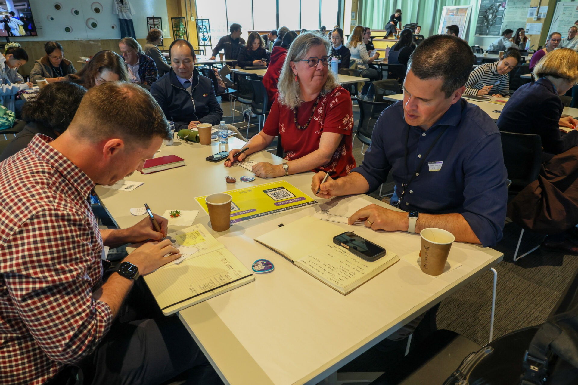 Participants work together with coloured paper and pens.